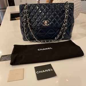 Chanel In The Business blue patent vinyl maxi flap purse.